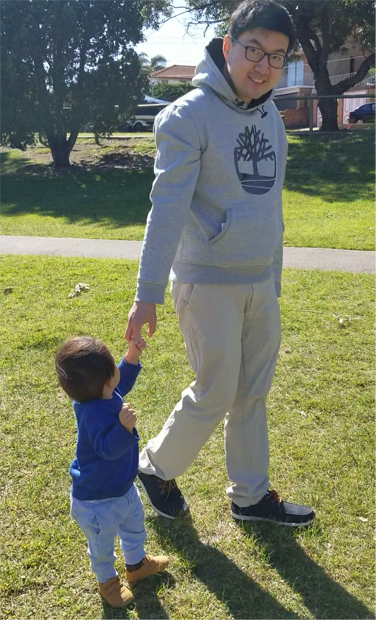 Dr Ben Lam with son walking